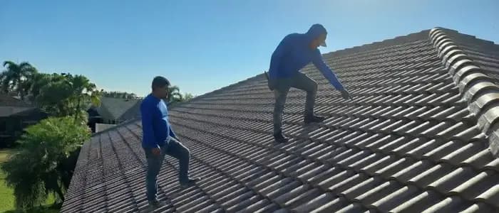 Roofing technician performing an inspection